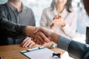 company leader shake employee hand after talking about the employee FMLA leave request