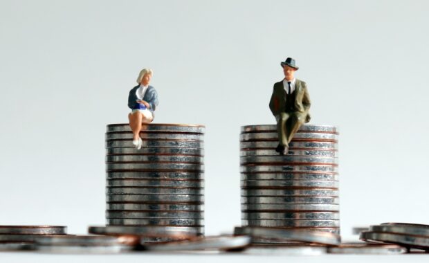 Why Equal Pay Matters In The Workplace-Man and Women Dummy Sitting on Equals Coins