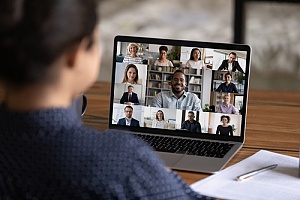 an employee meeting with her coworkers over video conferencing software
