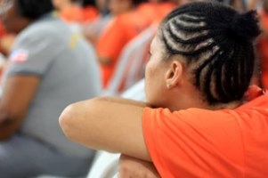 female inmate sitting sad in jail