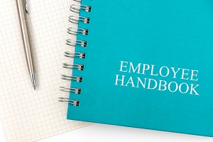 employee handbook or manual with a pen