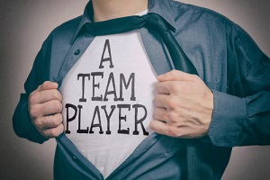man showing a team player tittle on t-shirt
