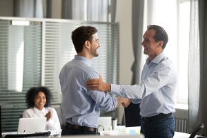 ceo promoting motivating worker shaking hands congratulating with achievement promising respect