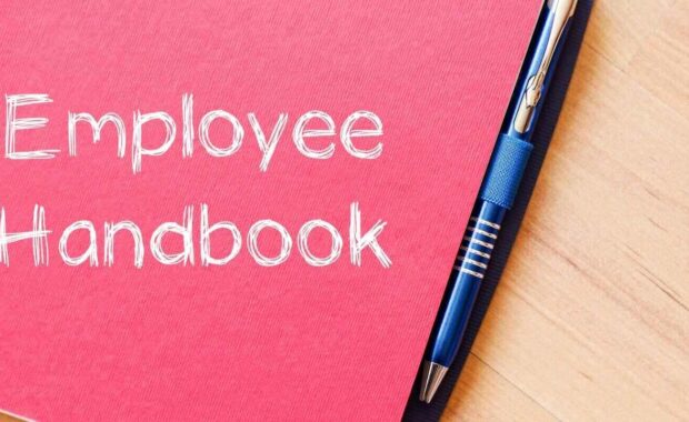 employee handbook text concept write on notebook