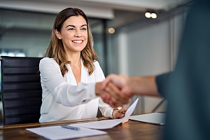HR System Management specialist shaking hands with business owner